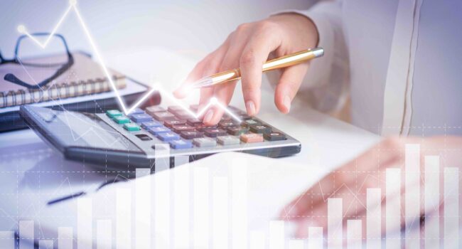 Accountant calculating profit with financial analysis graphs